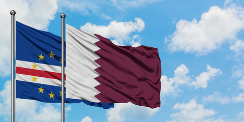 Cape Verde and Qatar flag waving in the wind against white cloudy blue sky together. Diplomacy concept, international relations.