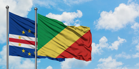 Cape Verde and Republic Of The Congo flag waving in the wind against white cloudy blue sky together. Diplomacy concept, international relations.