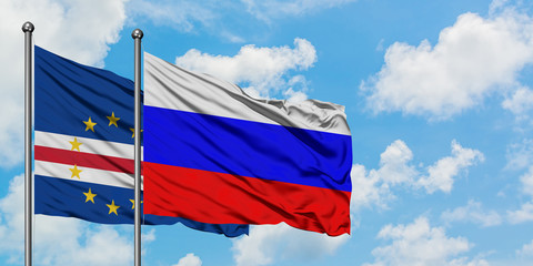 Cape Verde and Russia flag waving in the wind against white cloudy blue sky together. Diplomacy concept, international relations.