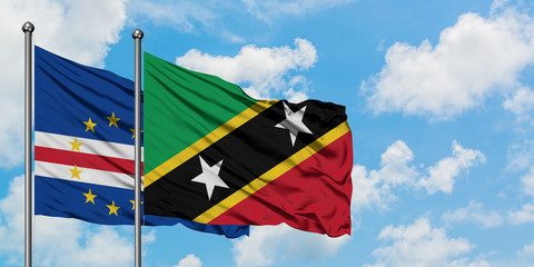 Cape Verde and Saint Kitts And Nevis flag waving in the wind against white cloudy blue sky together. Diplomacy concept, international relations.