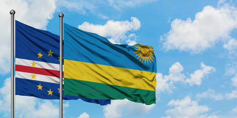 Cape Verde and Rwanda flag waving in the wind against white cloudy blue sky together. Diplomacy concept, international relations.
