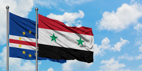 Cape Verde and Syria flag waving in the wind against white cloudy blue sky together. Diplomacy concept, international relations.