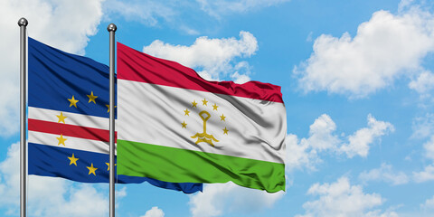 Cape Verde and Tajikistan flag waving in the wind against white cloudy blue sky together. Diplomacy concept, international relations.