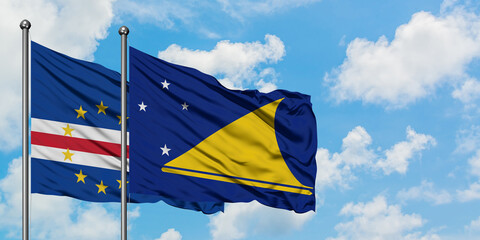 Cape Verde and Tokelau flag waving in the wind against white cloudy blue sky together. Diplomacy concept, international relations.