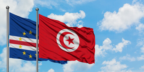 Cape Verde and Tunisia flag waving in the wind against white cloudy blue sky together. Diplomacy concept, international relations.