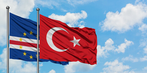 Cape Verde and Turkey flag waving in the wind against white cloudy blue sky together. Diplomacy concept, international relations.