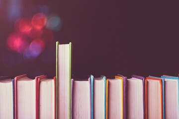 Old books in row on dark  background