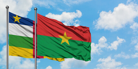 Central African Republic and Burkina Faso flag waving in the wind against white cloudy blue sky together. Diplomacy concept, international relations.