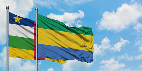Central African Republic and Gabon flag waving in the wind against white cloudy blue sky together....