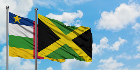 Central African Republic and Jamaica flag waving in the wind against white cloudy blue sky together. Diplomacy concept, international relations.