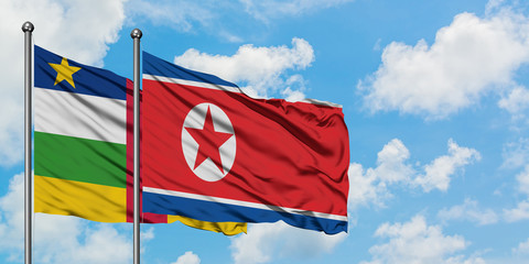 Central African Republic and North Korea flag waving in the wind against white cloudy blue sky together. Diplomacy concept, international relations.
