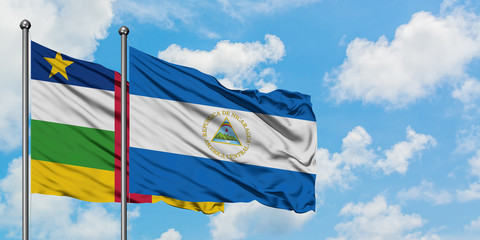 Central African Republic and Nicaragua flag waving in the wind against white cloudy blue sky together. Diplomacy concept, international relations.