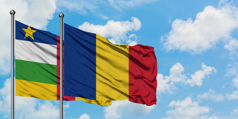 Central African Republic and Romania flag waving in the wind against white cloudy blue sky together. Diplomacy concept, international relations.