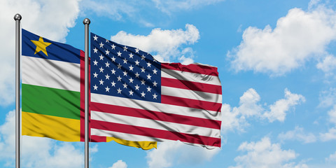 Central African Republic and United States flag waving in the wind against white cloudy blue sky together. Diplomacy concept, international relations.
