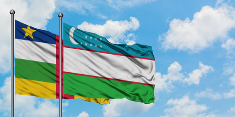 Central African Republic and Uzbekistan flag waving in the wind against white cloudy blue sky together. Diplomacy concept, international relations.