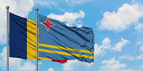 Chad and Aruba flag waving in the wind against white cloudy blue sky together. Diplomacy concept, international relations.