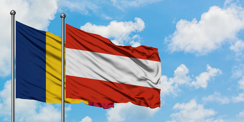 Chad and Austria flag waving in the wind against white cloudy blue sky together. Diplomacy concept, international relations.