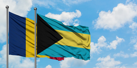Chad and Bahamas flag waving in the wind against white cloudy blue sky together. Diplomacy concept, international relations.