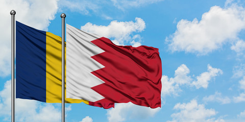 Chad and Bahrain flag waving in the wind against white cloudy blue sky together. Diplomacy concept,...