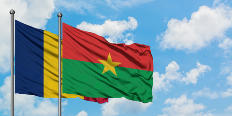 Chad and Burkina Faso flag waving in the wind against white cloudy blue sky together. Diplomacy concept, international relations.