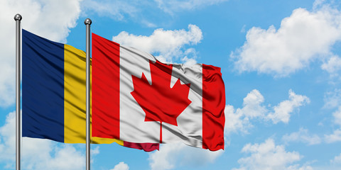 Chad and Canada flag waving in the wind against white cloudy blue sky together. Diplomacy concept, international relations.