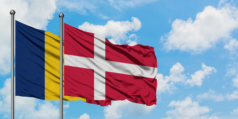 Chad and Denmark flag waving in the wind against white cloudy blue sky together. Diplomacy concept, international relations.
