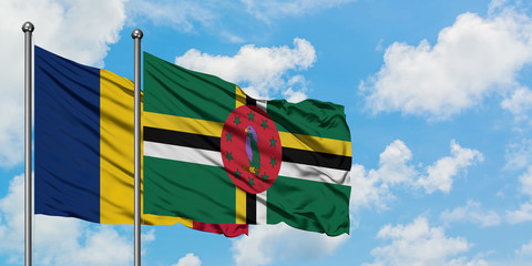 Chad and Dominica flag waving in the wind against white cloudy blue sky together. Diplomacy concept, international relations.