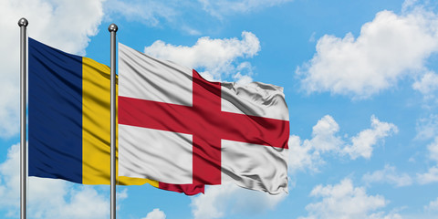 Chad and England flag waving in the wind against white cloudy blue sky together. Diplomacy concept, international relations.