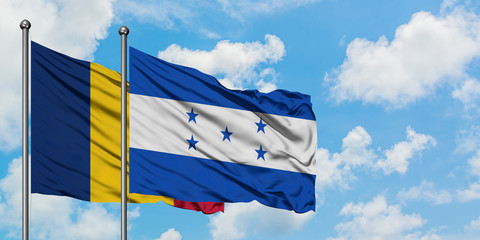 Chad and Honduras flag waving in the wind against white cloudy blue sky together. Diplomacy concept, international relations.