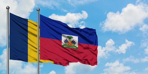Chad and Haiti flag waving in the wind against white cloudy blue sky together. Diplomacy concept, international relations.