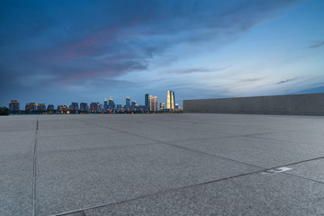 Panoramic skyline and buildings with empty square floor.