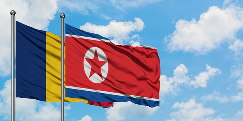 Chad and North Korea flag waving in the wind against white cloudy blue sky together. Diplomacy concept, international relations.