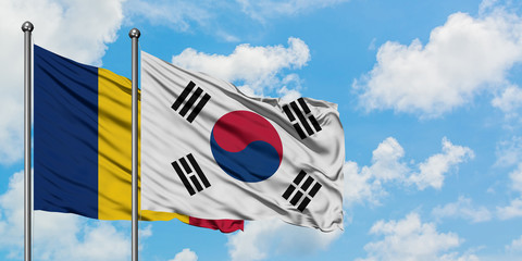 Chad and South Korea flag waving in the wind against white cloudy blue sky together. Diplomacy...