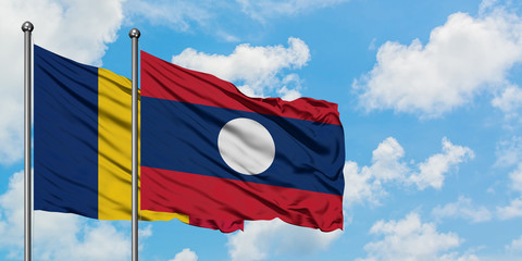 Chad and Laos flag waving in the wind against white cloudy blue sky together. Diplomacy concept,...