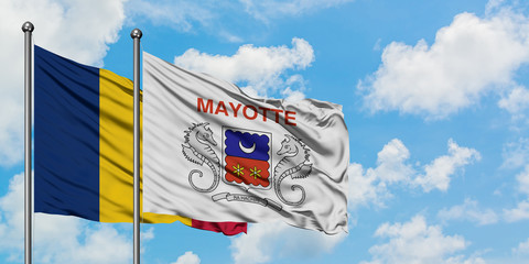 Chad and Mayotte flag waving in the wind against white cloudy blue sky together. Diplomacy concept, international relations.