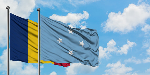 Chad and Micronesia flag waving in the wind against white cloudy blue sky together. Diplomacy...