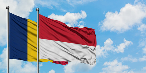 Chad and Monaco flag waving in the wind against white cloudy blue sky together. Diplomacy concept, international relations.