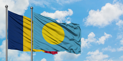 Chad and Palau flag waving in the wind against white cloudy blue sky together. Diplomacy concept, international relations.