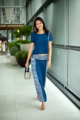 Asian Beautiful Woman in Indigo Blue local cotton dress present new collection on ready to wear clothes in fashion store which has big windows and blur background for copy space text logo