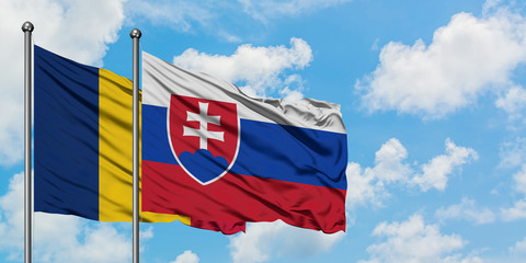 Chad and Slovakia flag waving in the wind against white cloudy blue sky together. Diplomacy concept, international relations.