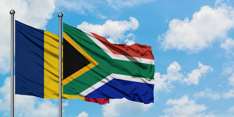 Chad and South Africa flag waving in the wind against white cloudy blue sky together. Diplomacy concept, international relations.