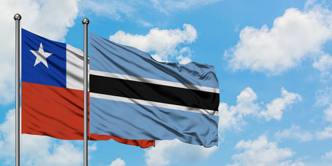 Chile and Botswana flag waving in the wind against white cloudy blue sky together. Diplomacy concept, international relations.