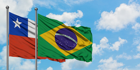 Chile and Brazil flag waving in the wind against white cloudy blue sky together. Diplomacy concept,...