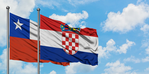 Chile and Croatia flag waving in the wind against white cloudy blue sky together. Diplomacy concept, international relations.
