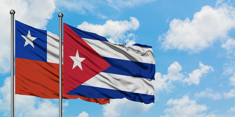 Chile and Cuba flag waving in the wind against white cloudy blue sky together. Diplomacy concept, international relations.