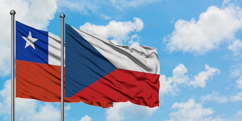 Chile and Czech Republic flag waving in the wind against white cloudy blue sky together. Diplomacy concept, international relations.