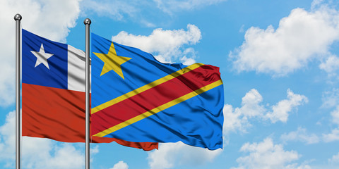 Chile and Congo flag waving in the wind against white cloudy blue sky together. Diplomacy concept, international relations.