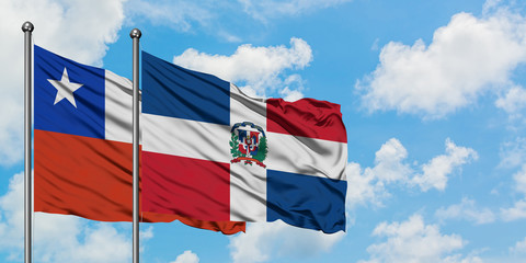 Chile and Dominican Republic flag waving in the wind against white cloudy blue sky together. Diplomacy concept, international relations.