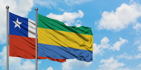 Chile and Gabon flag waving in the wind against white cloudy blue sky together. Diplomacy concept, international relations.