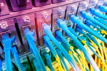 Fiber Optic cables connected to an optic ports and Network cables connected to ethernet ports